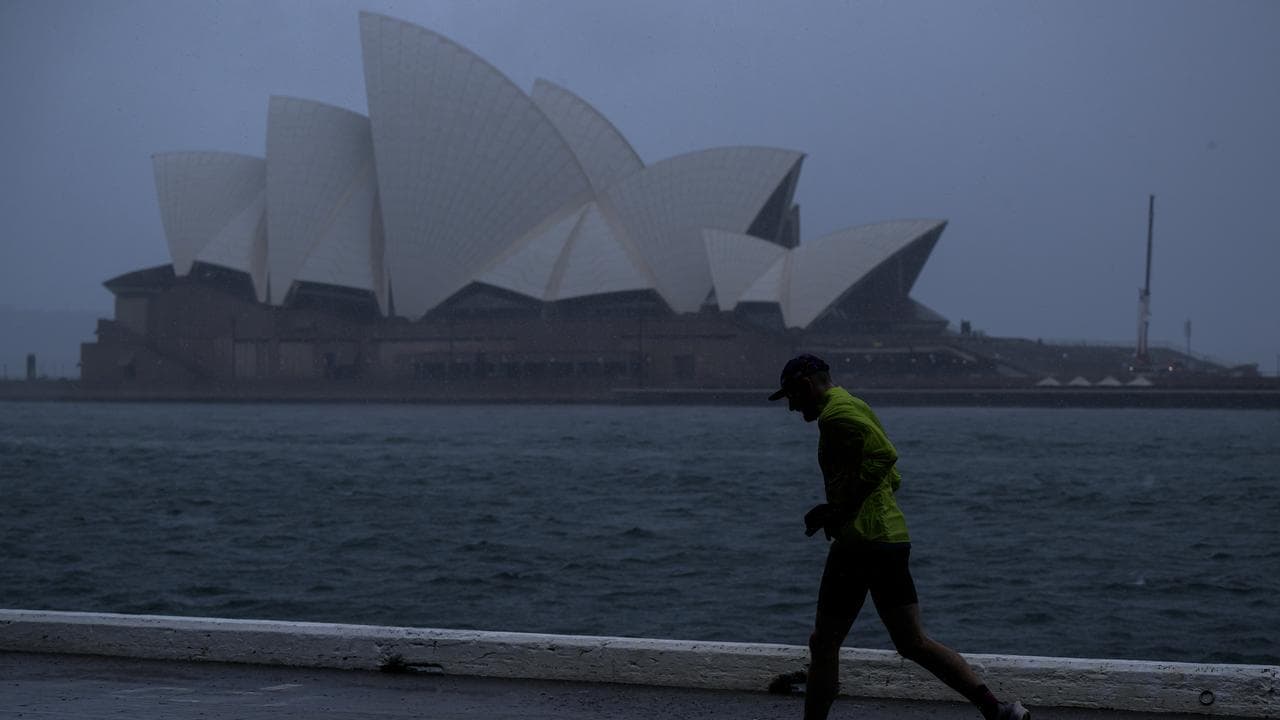 A jogger is seen in the rain