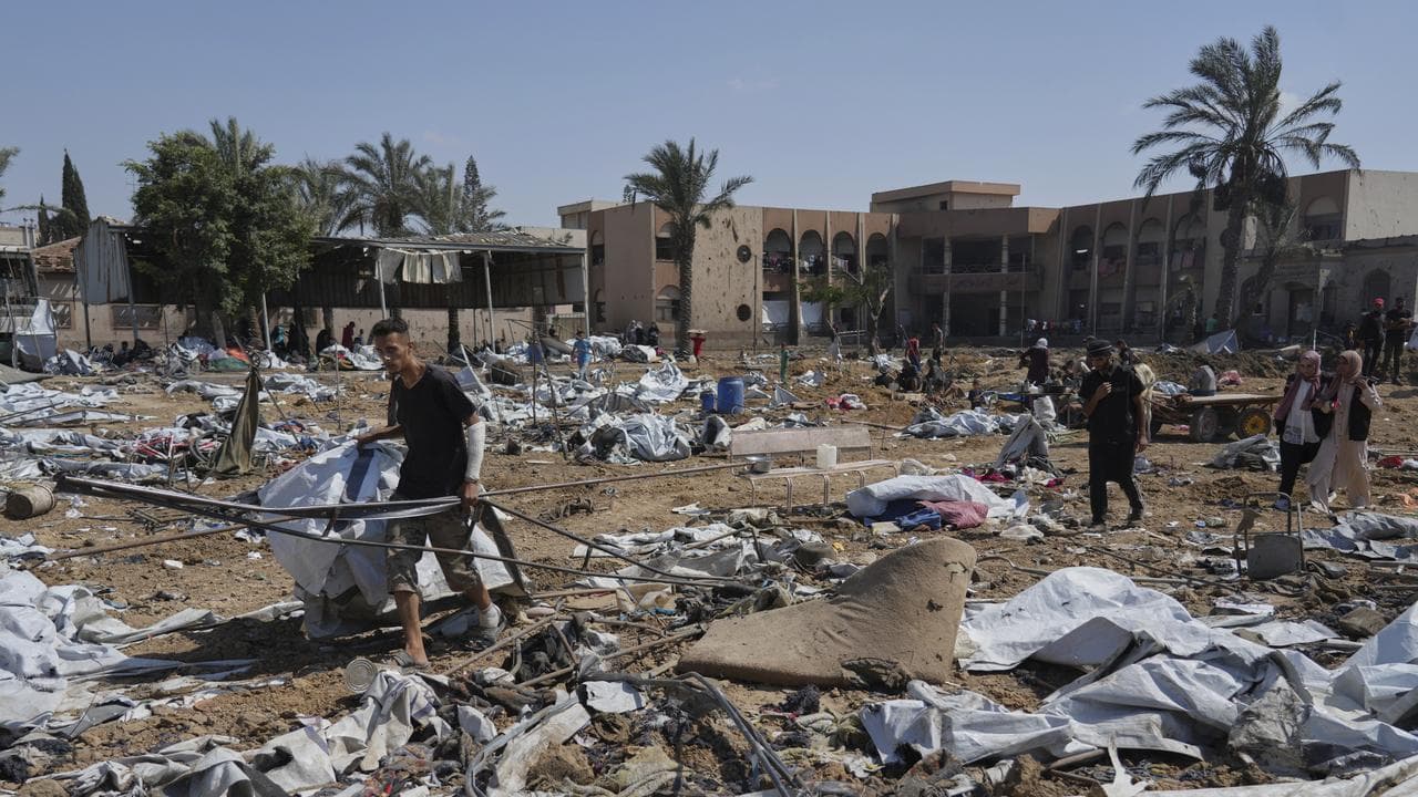 Palestinians check the destruction after military strikes