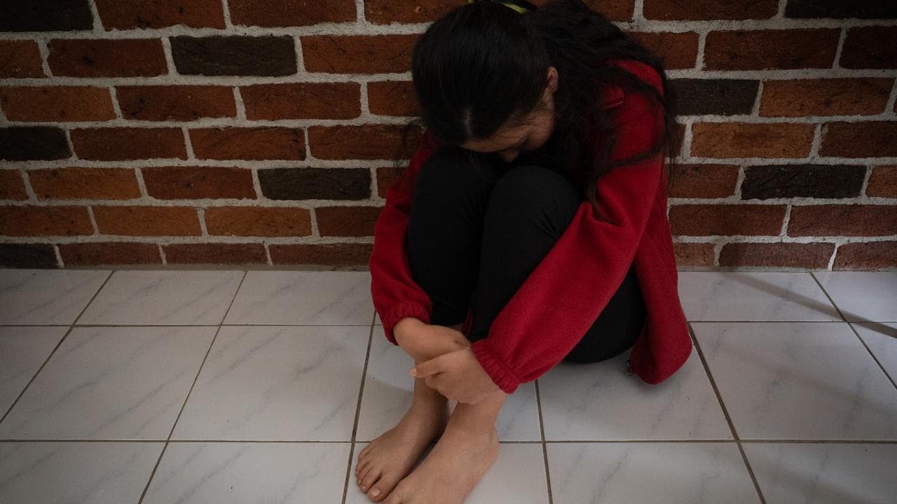 A girl in a posed photo to illustrate child abuse