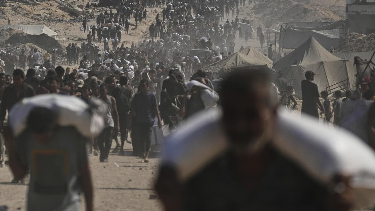 Palestinians carry sacks of flour
