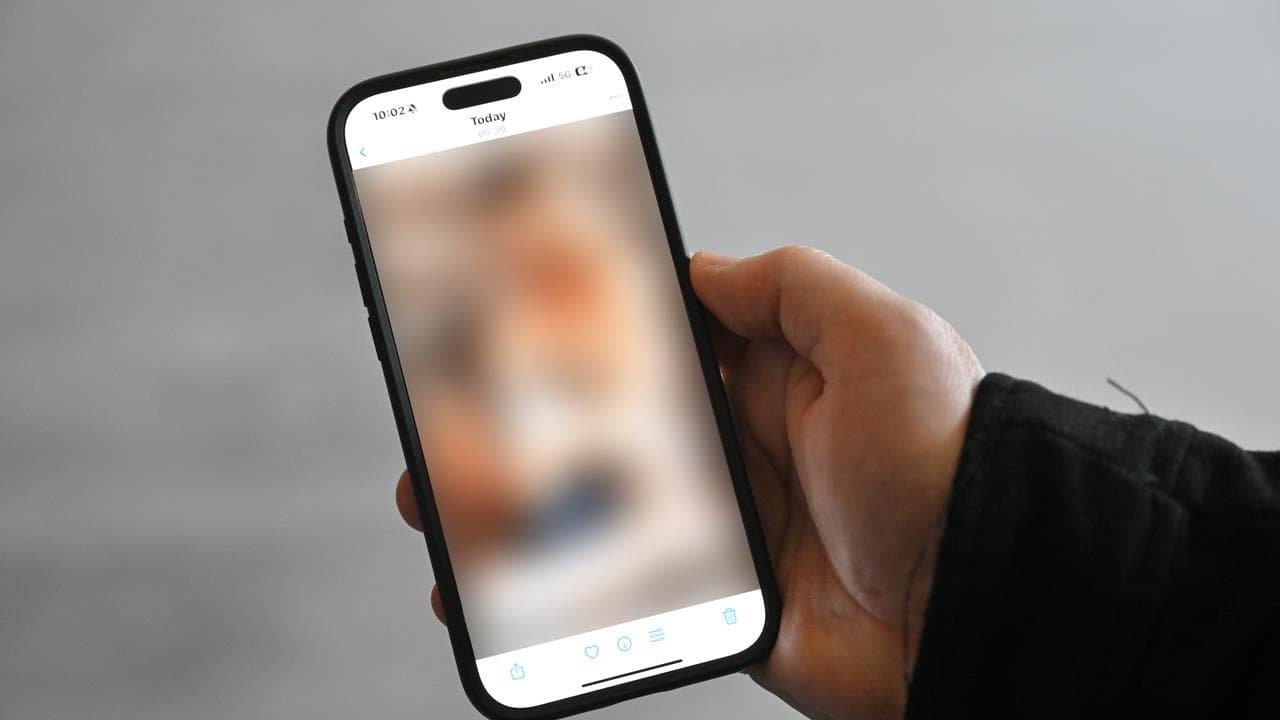 A blurred child abuse image on a phone
