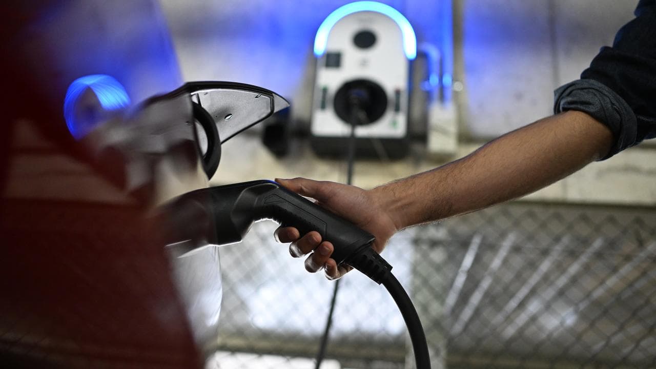 A person charging an e-vehicle