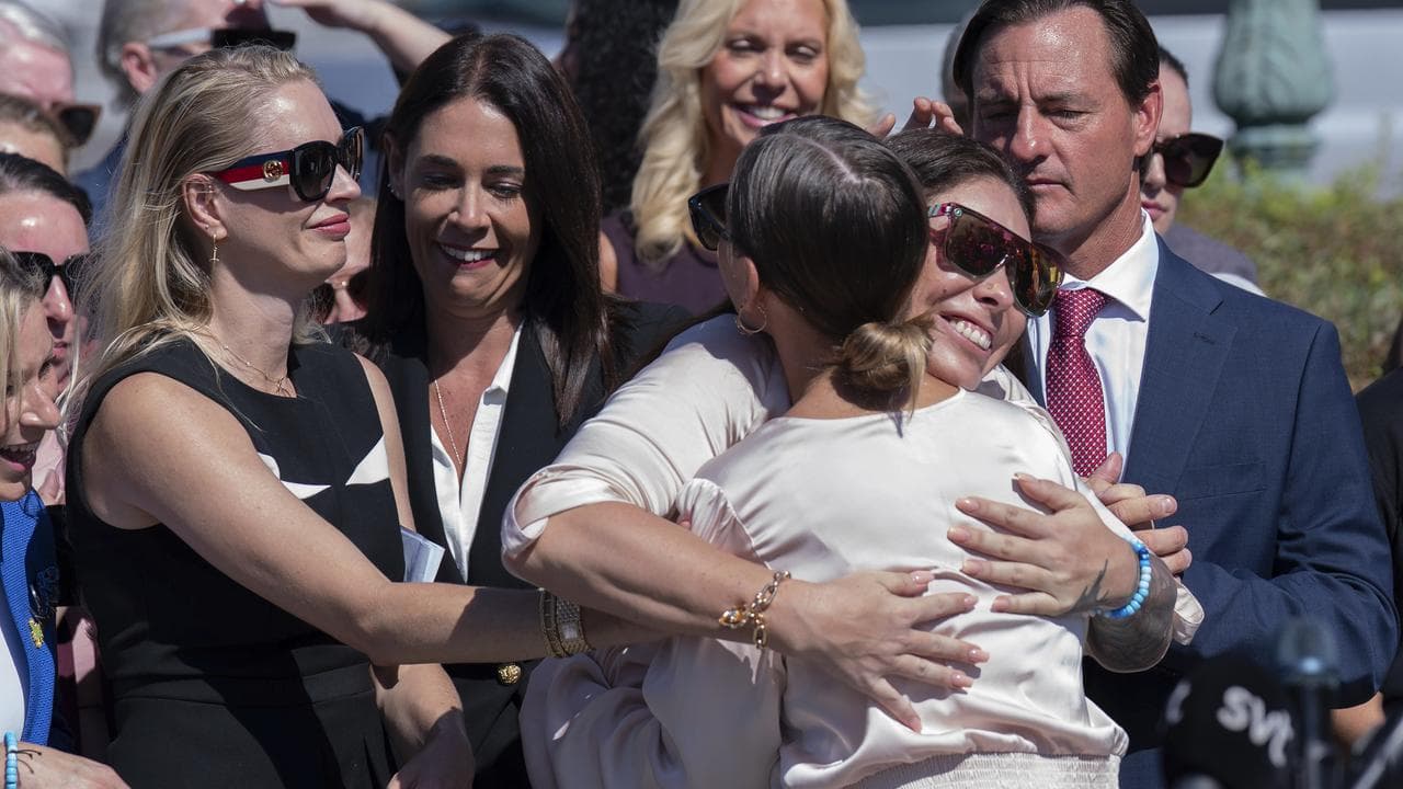 Women hug at rally outside US Capitol