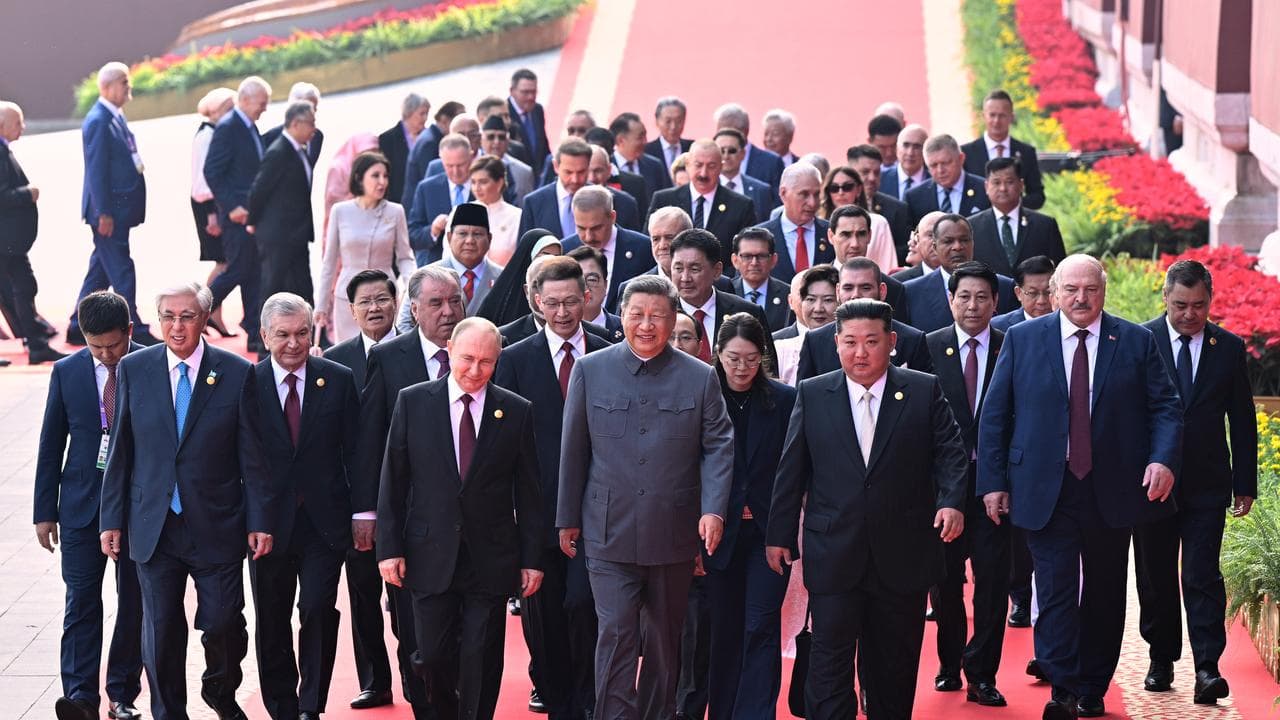 Mr Andrews at the back of the crowd, almost directly behind Mr Putin.