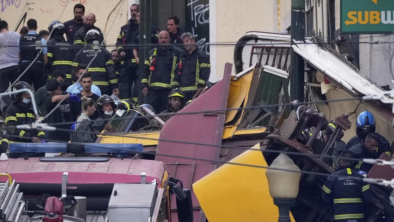 Emergency teams at the site of a derailed streetcar in Lisbon