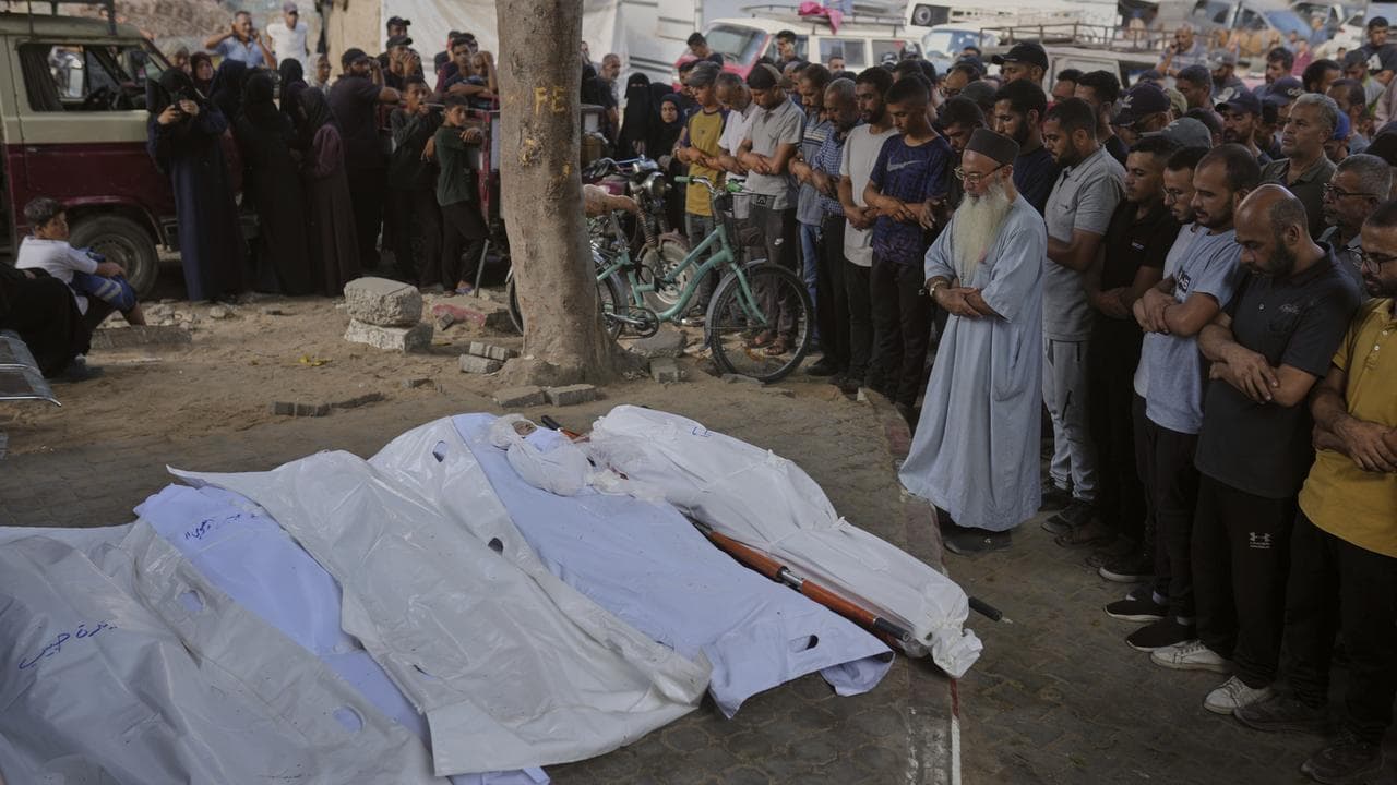 Palestinians mourn people killed in an Israeli strike in Gaza City