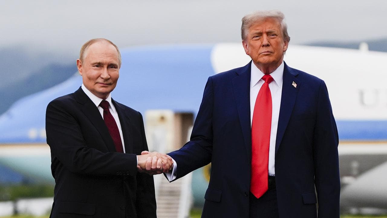President Donald Trump greets Russia's President Vladimir Putin