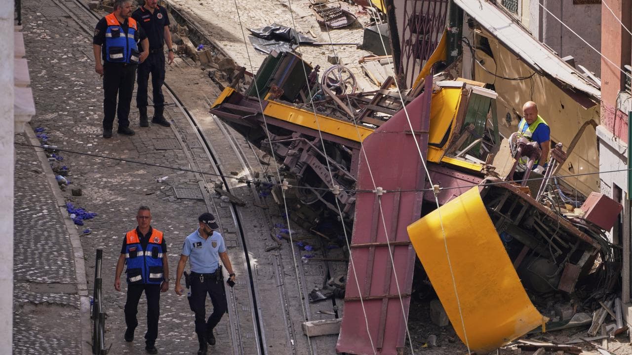 Police inspect where a streetcar crashed in Lisbon, Portugal