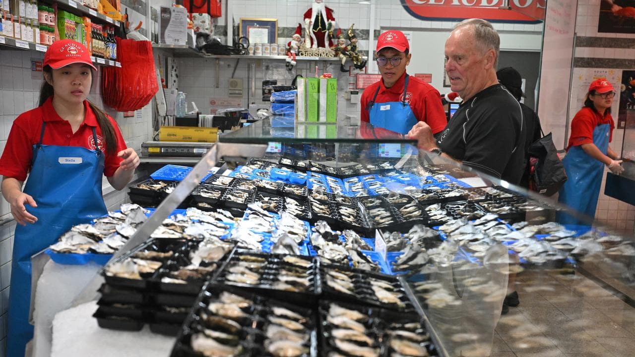 Traders serve and display seafood
