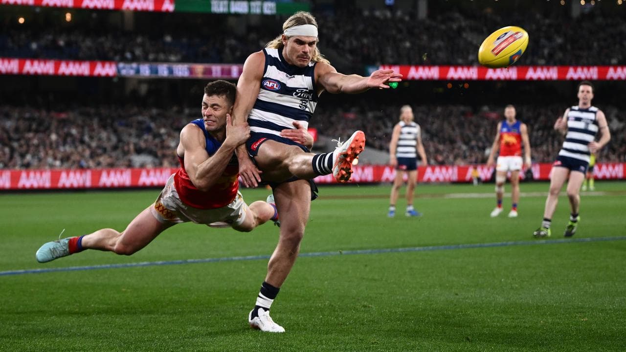 Josh Dunkley of the Lions tackles Bailey Smith of Geelong
