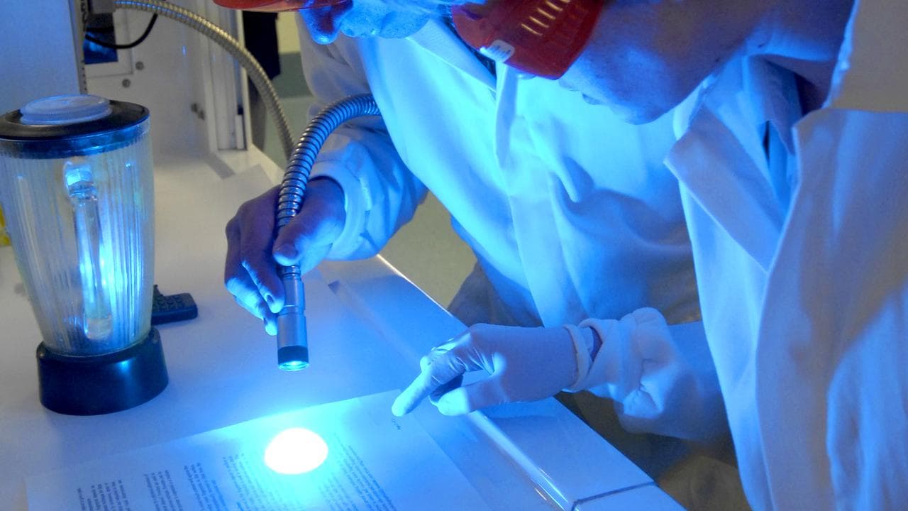 Forensic police testing fingerprints (file)