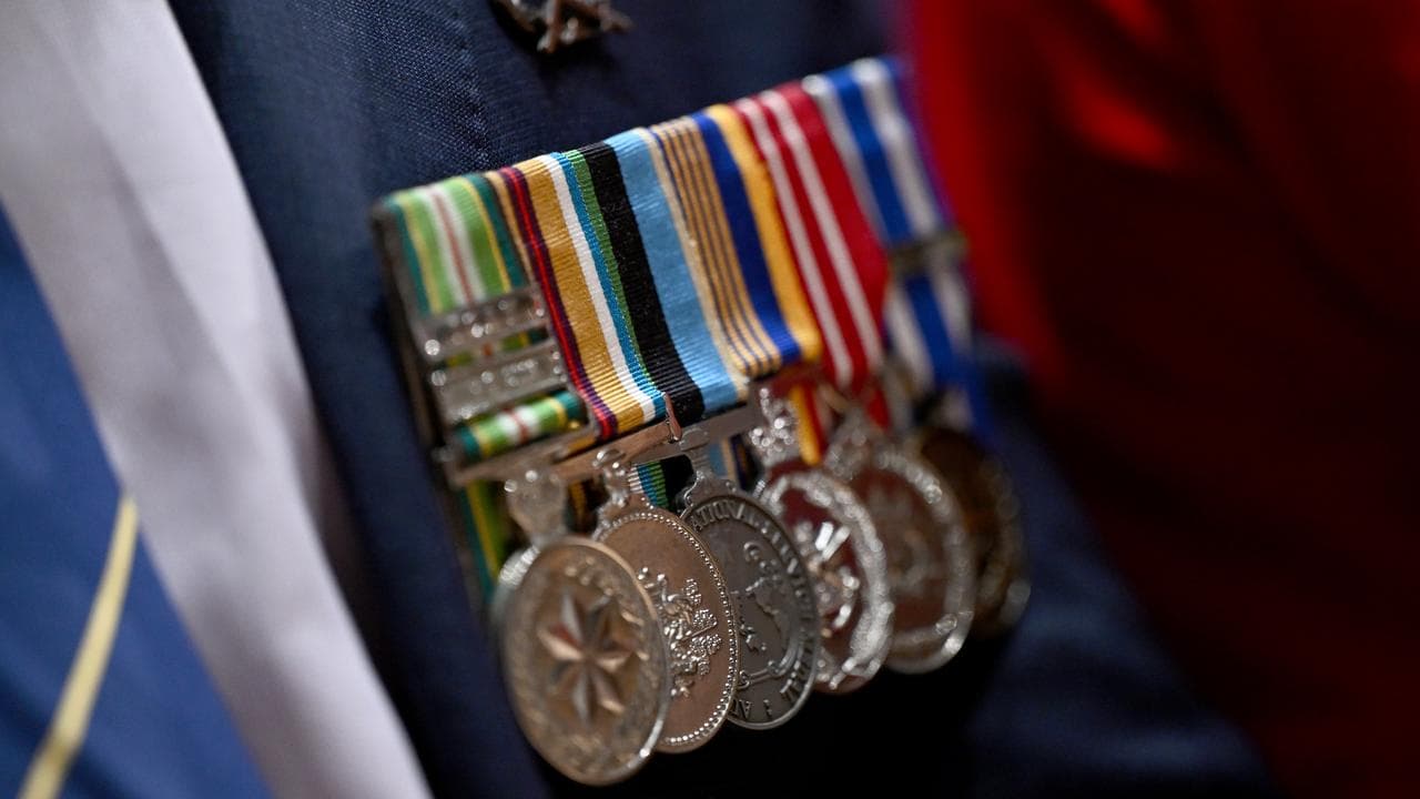 Medals of an attendee of a veterans suicide inquiry closing ceremony