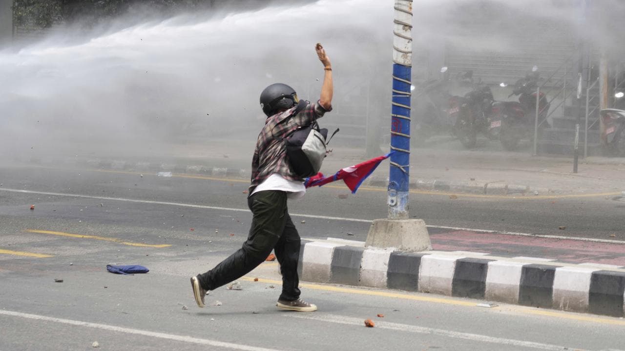 A protester clashes with the police in Kathmandu, Nepal