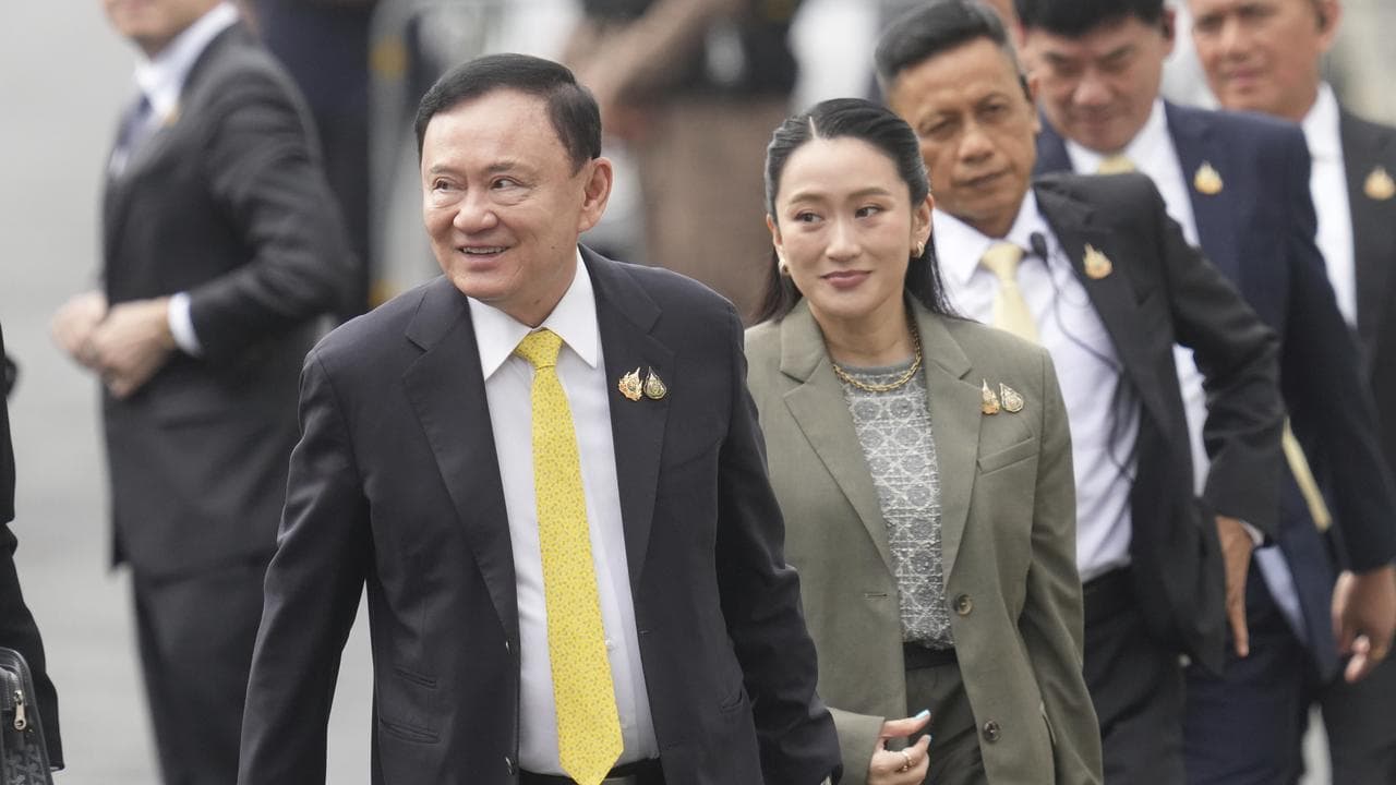 Thaksin Shinawatra and Paetongtarn Shinawatra outside court in Bangkok