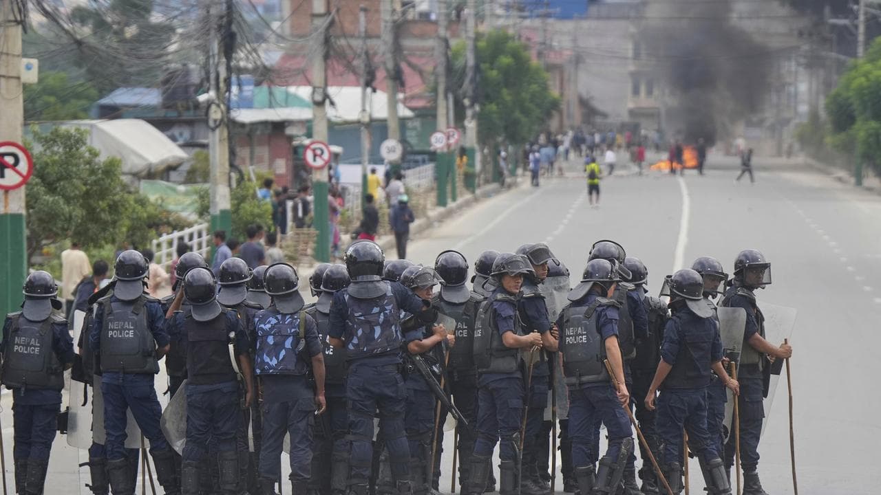 Policemen in riot gear stand guard on a street in Kathmandu, Nepal