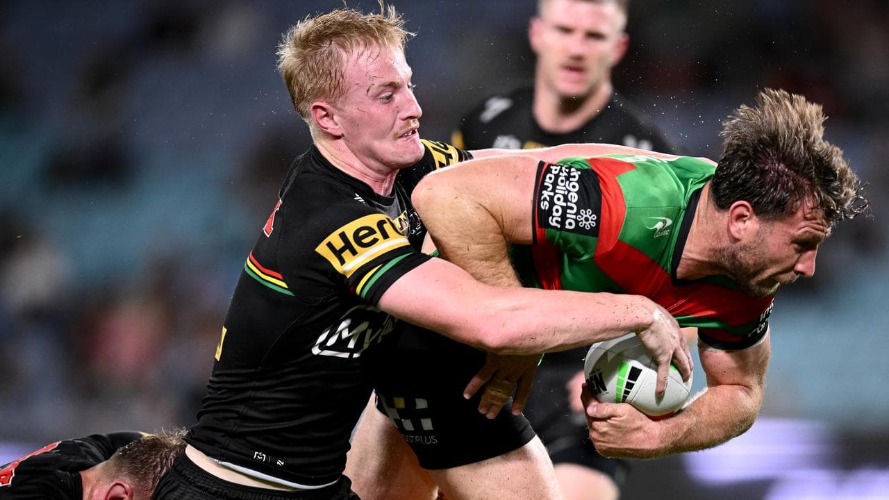 Jai Arrow of the Rabbitohs is tackled by Tom Jenkins of the Panthers
