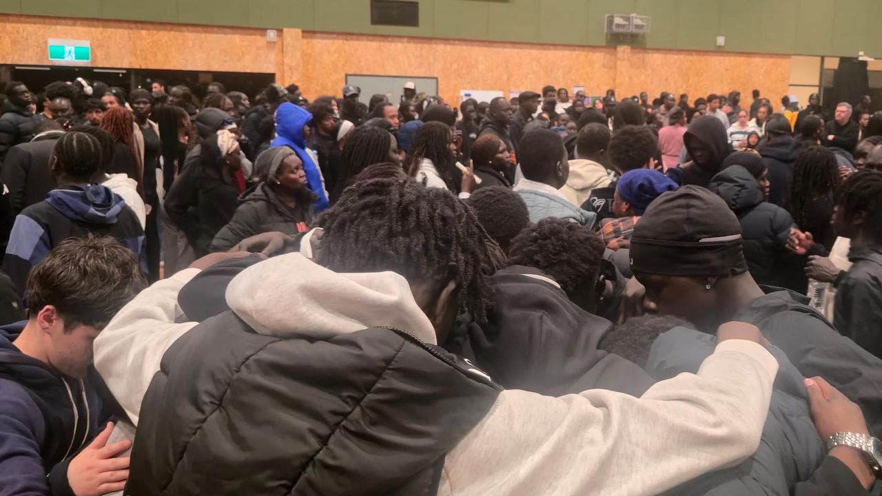 Mourners during a vigil at a local basketball centre