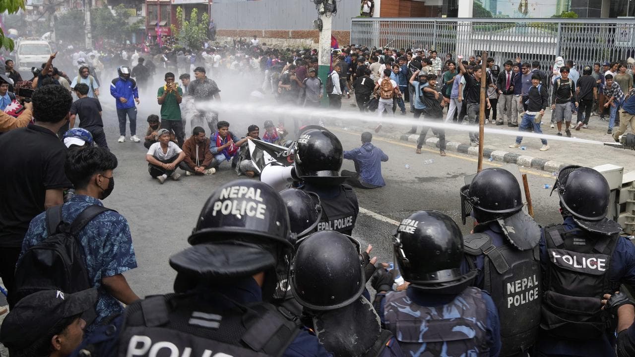 Police use a water cannon on protesters outside Nepal's parliament