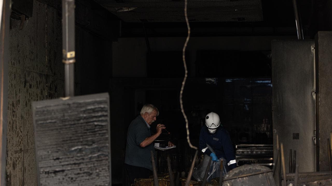 Forensic Police at a shop fire linked to the tobacco wars