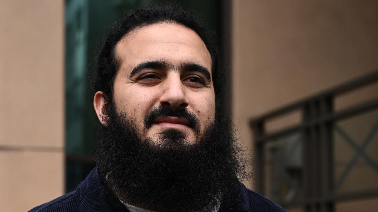 Yusuf Issam (centre) leaves the Melbourne Magistrates Court