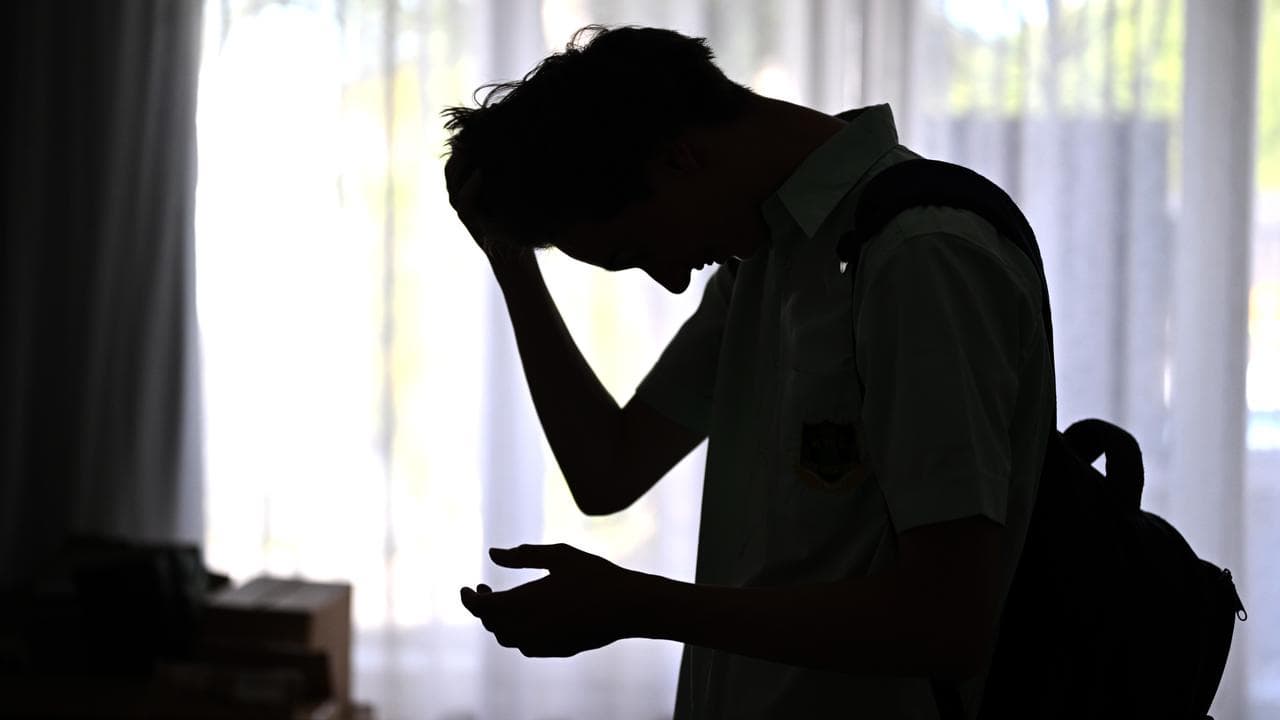A silhouette of a male high school student