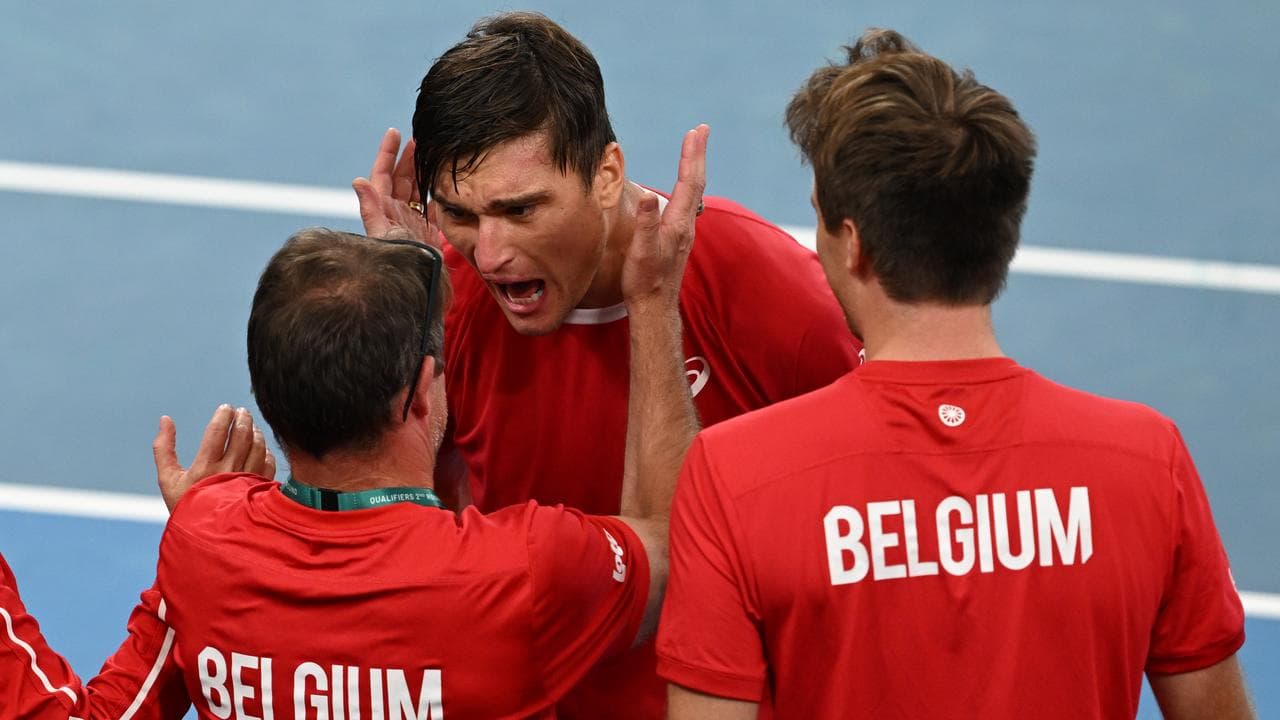 Raphael Collignon (centre) celebrates with teammates