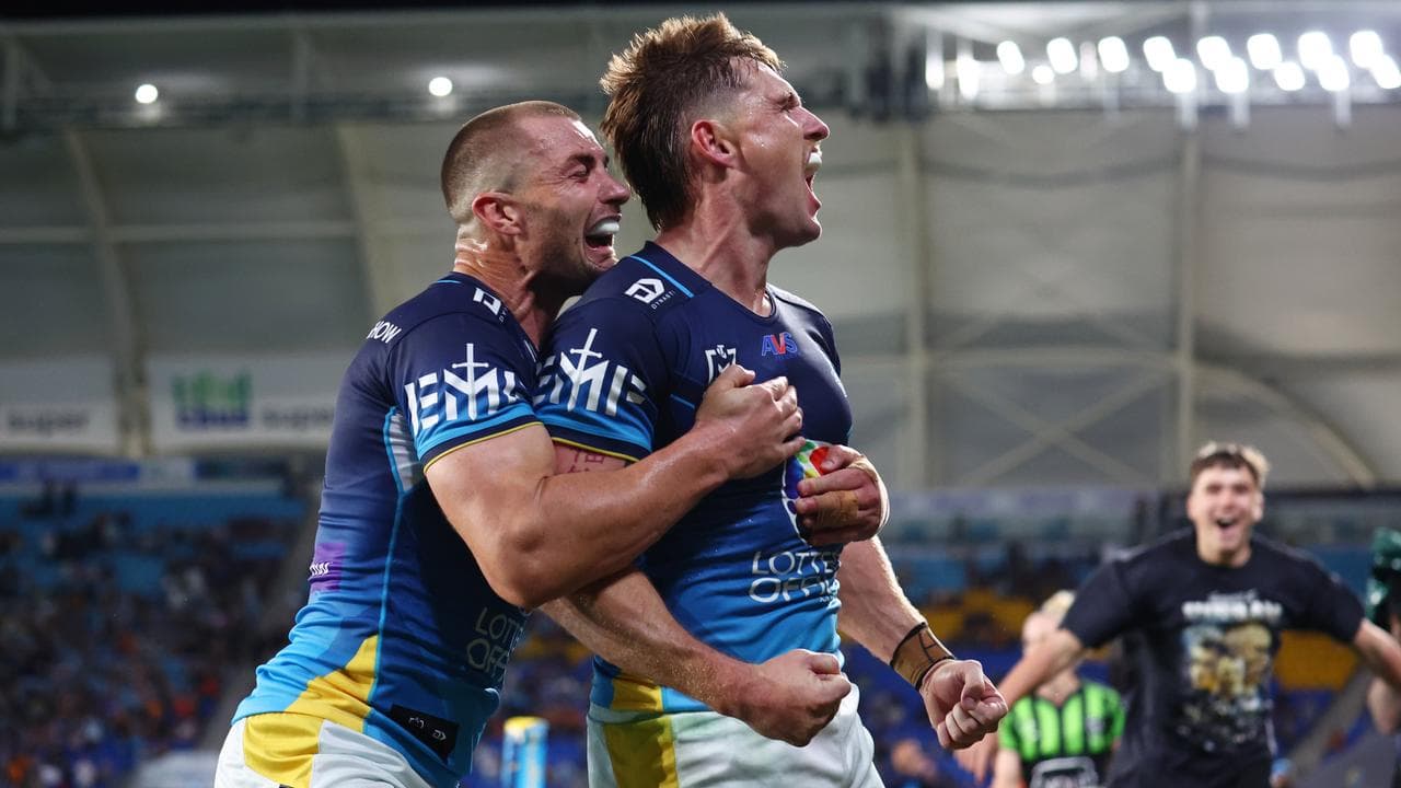 AJ Brimson of the Titans celebrates scoring a try  with Kieran Foran