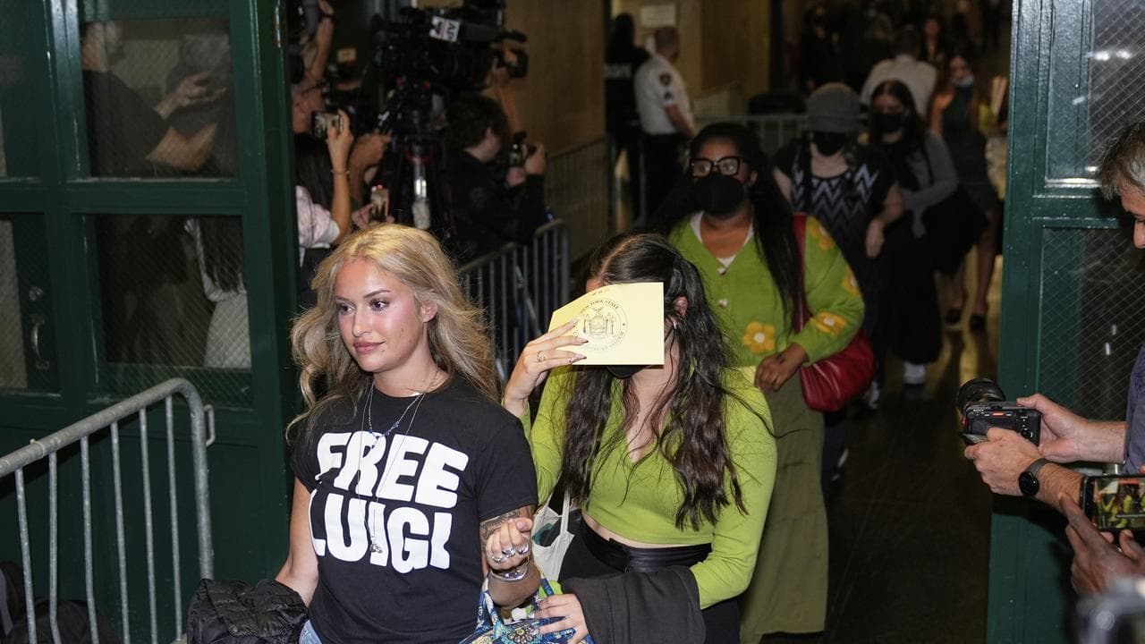 Members of the public enter a courtroom