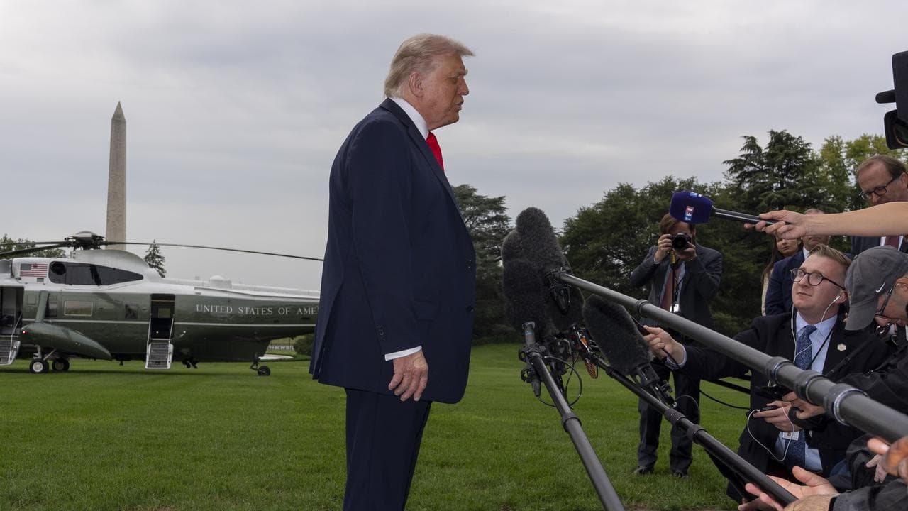 President Donald Trump speaks with reporters