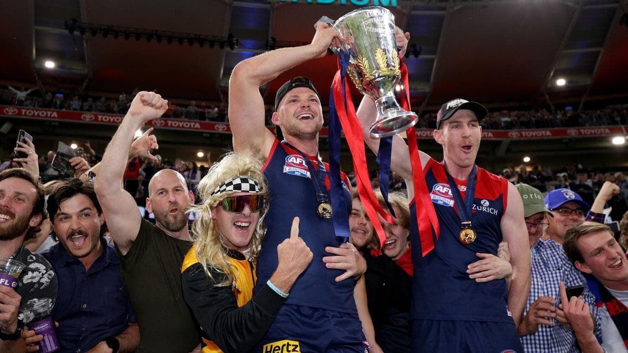 Steven May and Harrison Petty raise the premiership trophy.