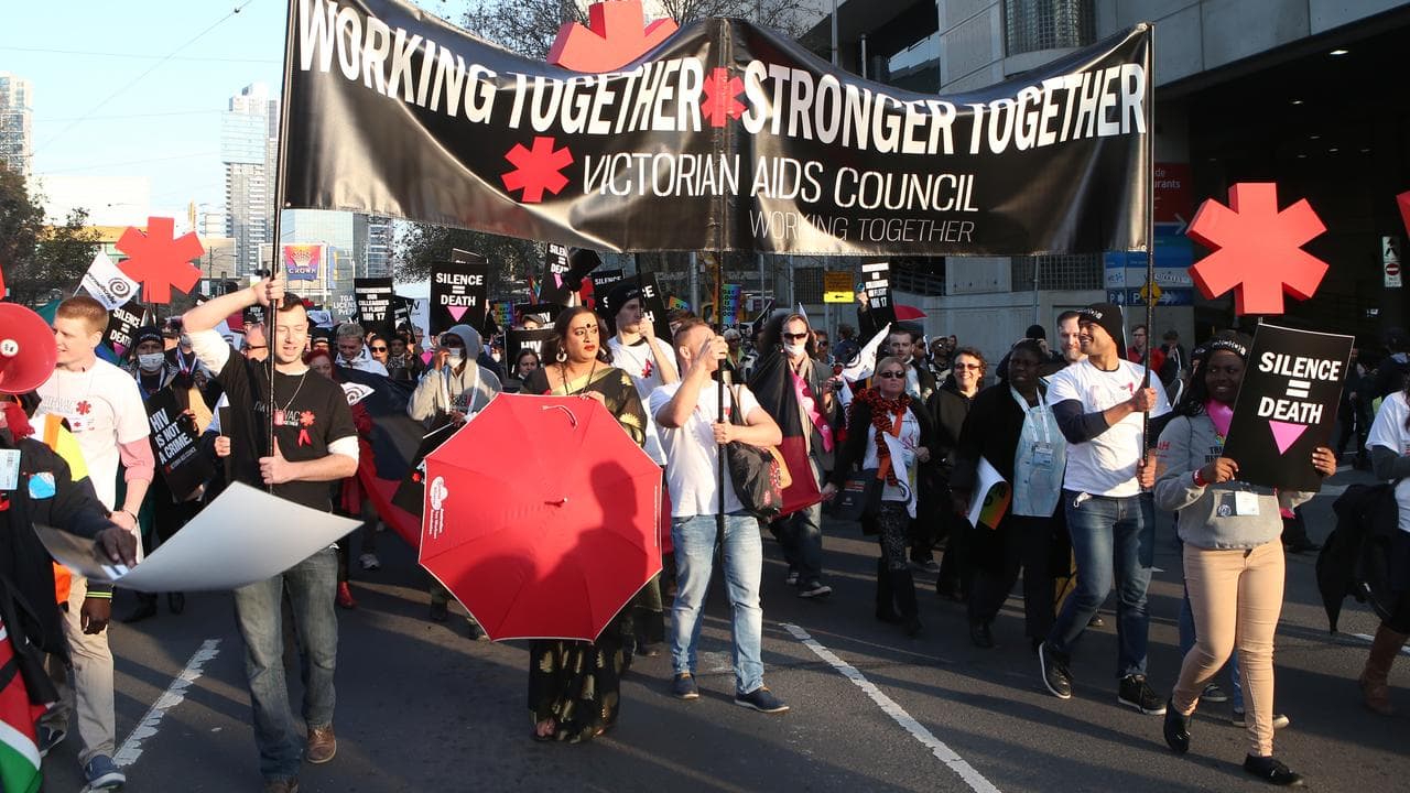 Protesters march in Melbourne in support of people with HIV and Aids
