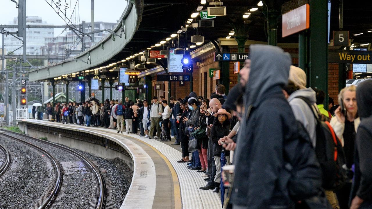 Commuters line the platform at Strathfield Station during delays