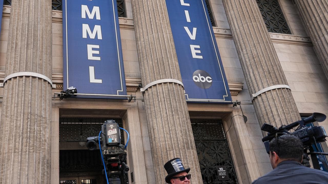Gregg Donovan holds a sign that says "Welcome Back Jimmy"