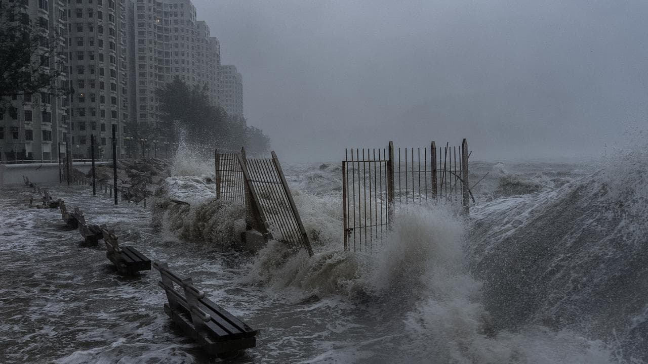 Waves crash against the waterfront in Hong Kong