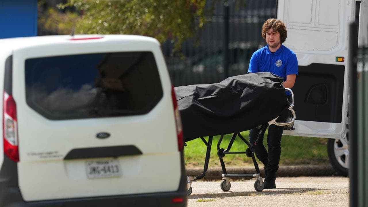 ICE shooter's body is placed in the medical examiner's van in Dallas