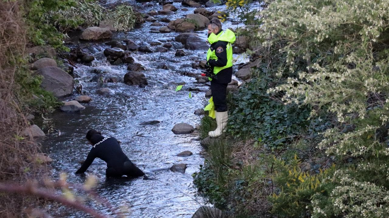 Police search a waterway