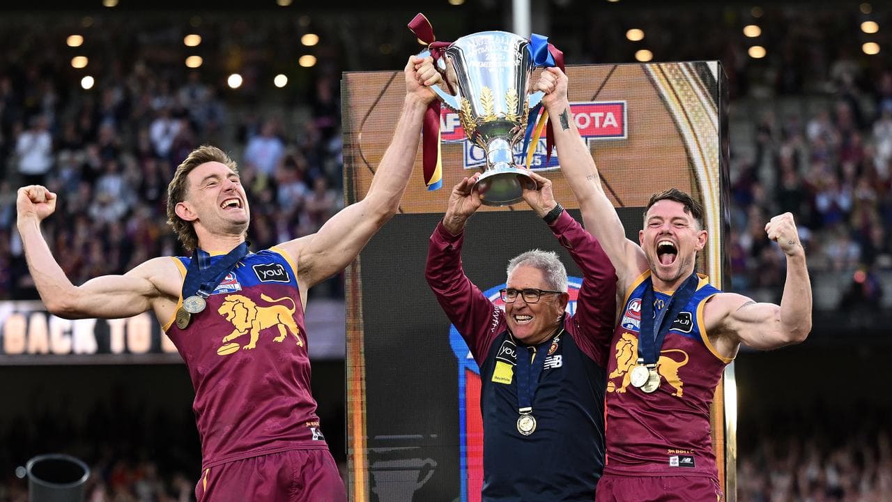 The Lions' Harris Andrews, coach Chris Fagan and Lachie Neale.