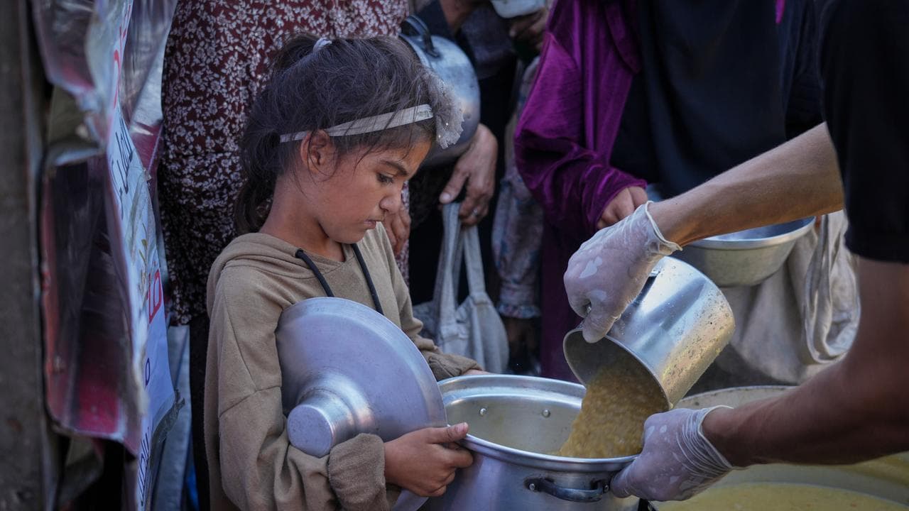 Girl gets donated food at a community kitchen