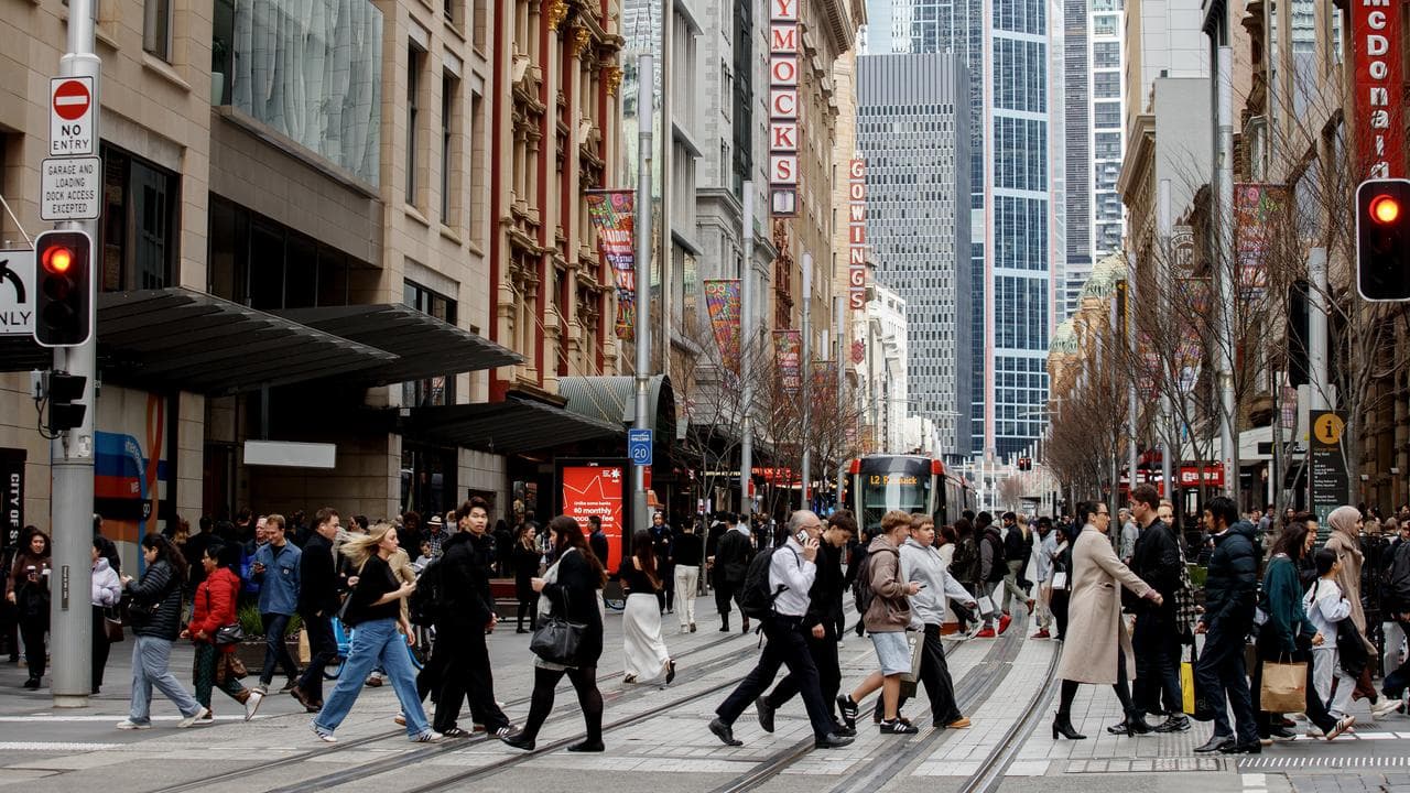 People move through George Street in the CBD