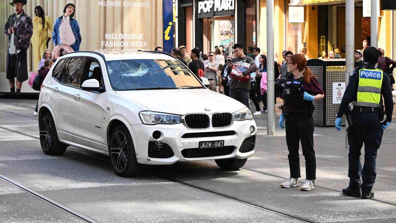 Victoria Police surround a BMW in Bourke St Mall