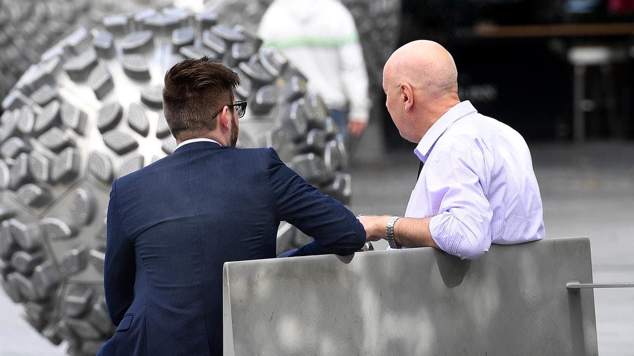 Two men sit and talk in central Brisbane