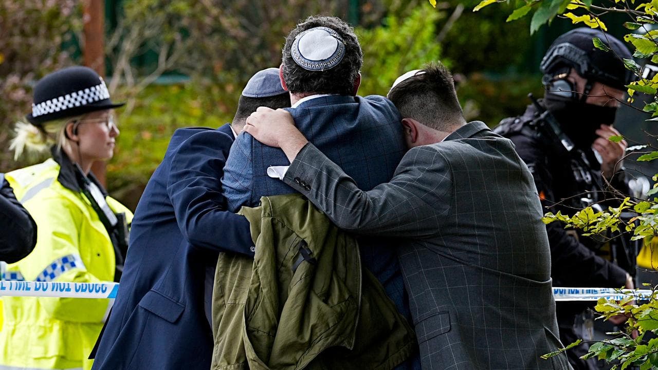 Members of the Jewish community comfort each other