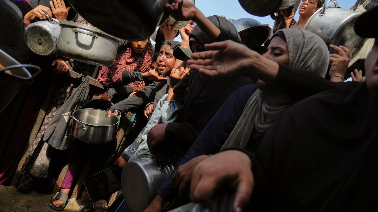 Palestinians at a community kitchen in Khan Younis, Gaza