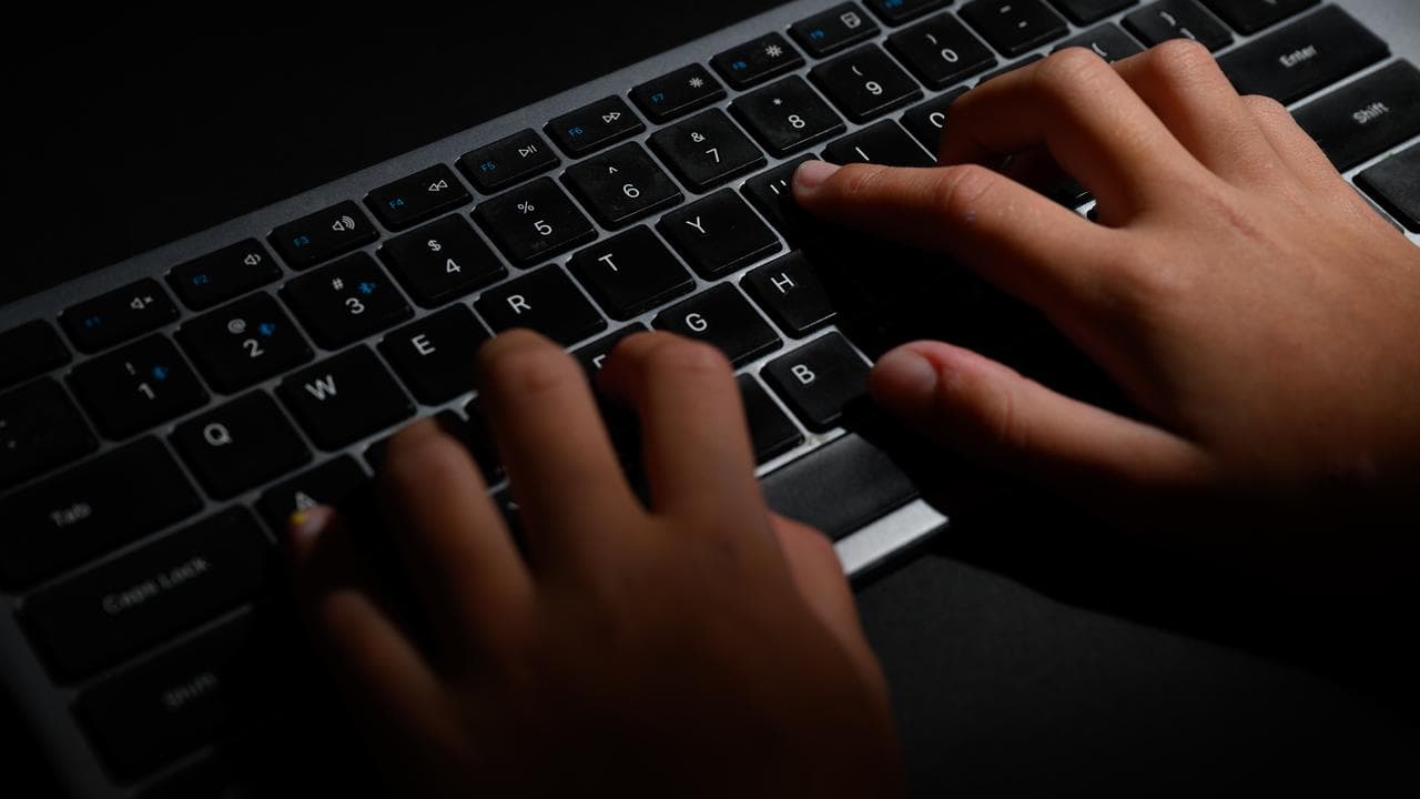 Hands typing on a keyboard (file image)