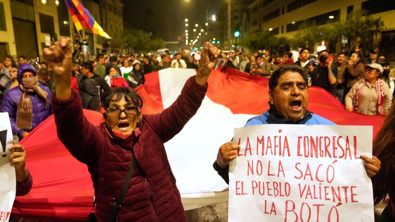 Demonstrators celebrate outside the congress building in Lima, Peru
