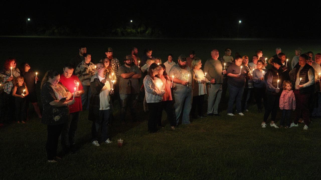 Residents attend a vigil