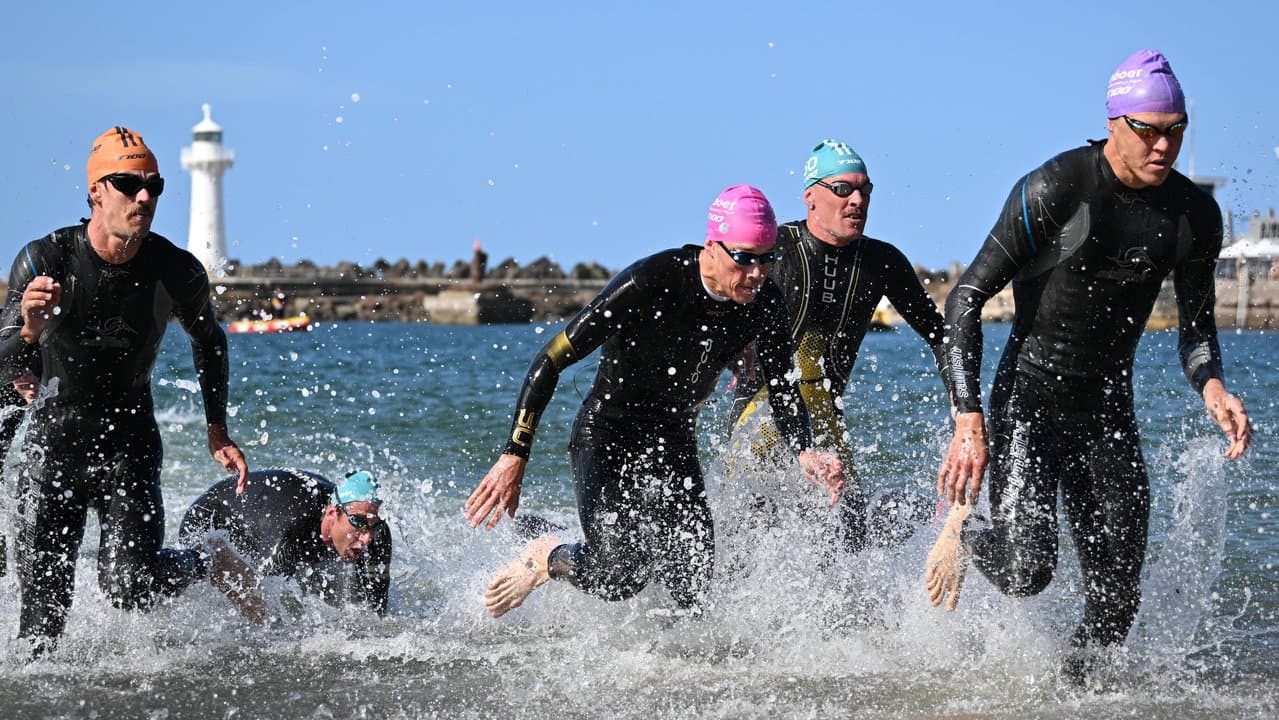 Competitors leave the water in the men’s T100