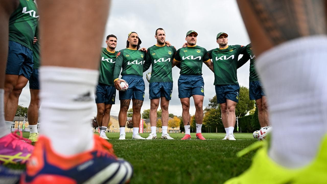 Kangaroos players hugging.