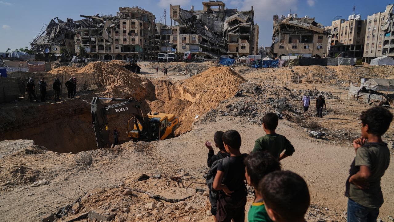 Egyptian workers search for the bodies of hostages in Khan Younis