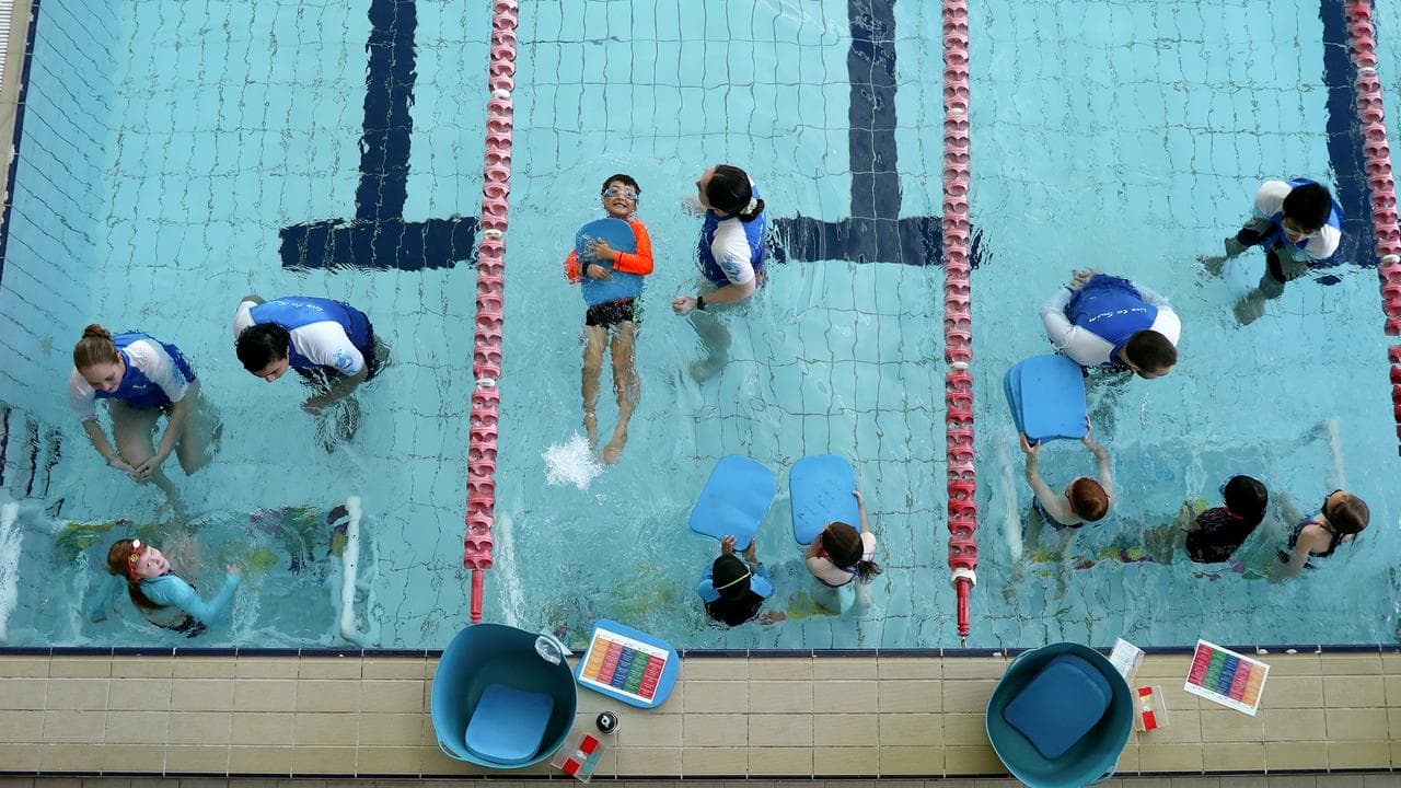 Kids participate in swimming lessons